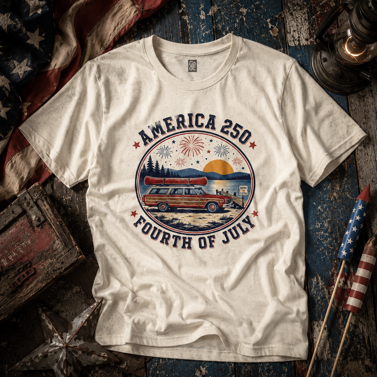 America 250 Fourth of July patriotic t-shirt featuring retro station wagon and fireworks graphic in vintage Americana lifestyle flat lay scene.