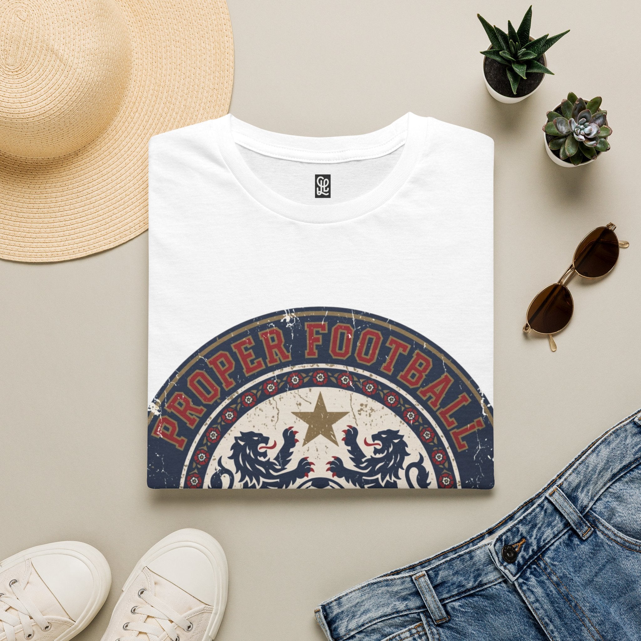 White color variant of oryggy "Proper Football" vintage crest t-shirt, retro soccer graphic tee with double-lion emblem for FIFA 2026.